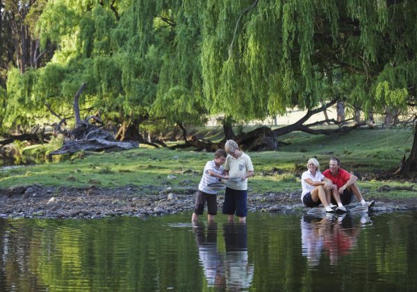 A family fossicking at a creek, near Inverell