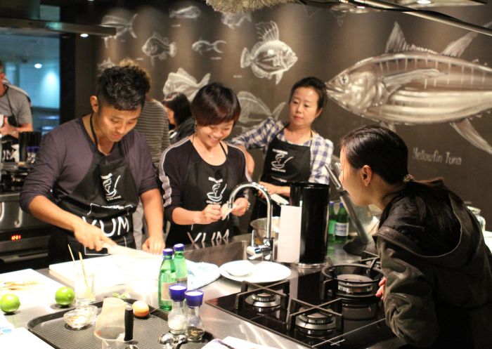 Small group enjoying a cooking class at the Sydney Seafood school