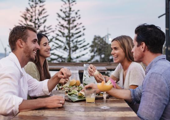 Friends enjoying food and drink at Mumbo Jumbos Beachhouse, Terrigal in Gosford, Central Coast