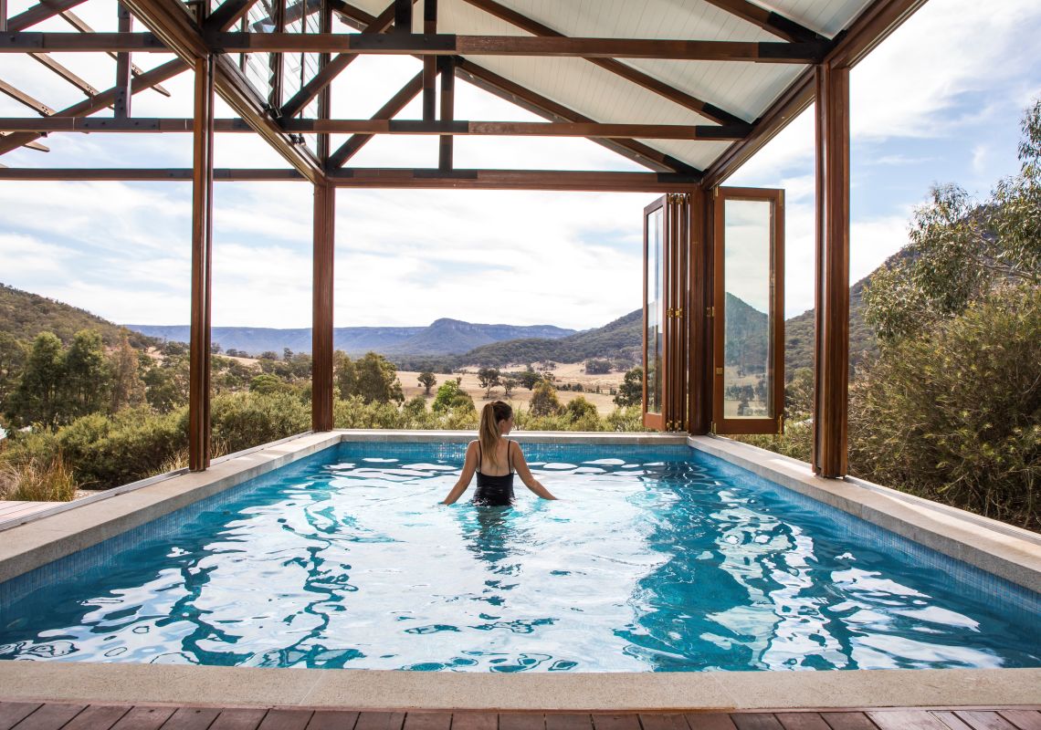Woman relaxing in a seven metre-long private pool at Emirates One&Only Wolgan Valley, Blue Mountains