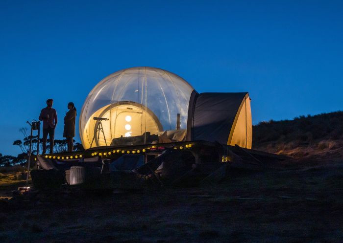 Couple relaxing in their Bubbletent Australia accommodation in the Capertee Valley