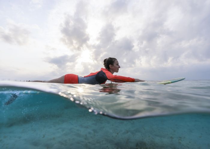 Woman enjoying a day of surfing at The Pass, Byron Bay