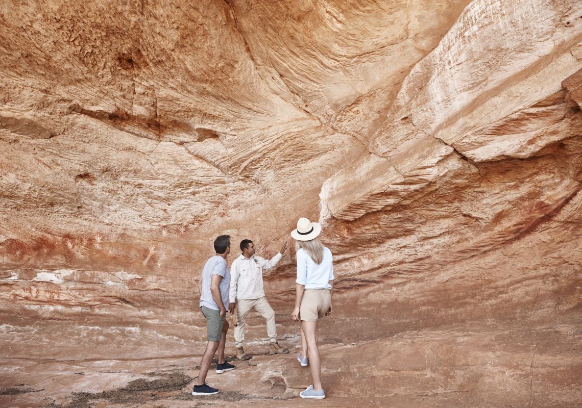 Mutawintji National Park tour guide Keanu Bates showing visitors Aboriginal rock art at Mutawintji Historic Site