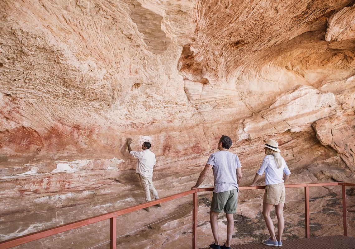 Mutawintji National Park tour guide Keanu Bates showing visitors Aboriginal rock art at Mutawintji Historic Site.