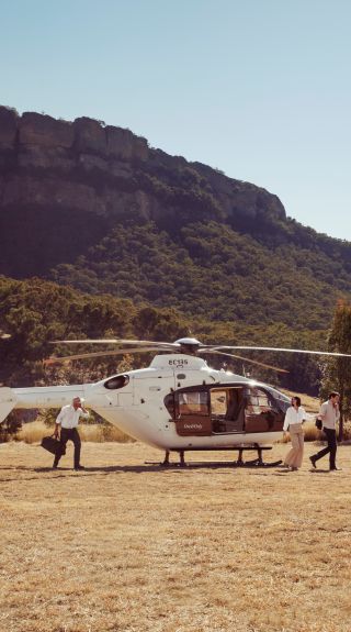 Couple ariving by helicopter at Emirates One&Only Wolgan Valley, Blue Mountains