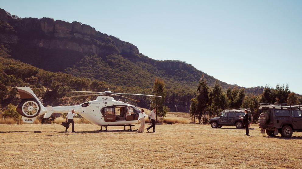 Couple ariving by helicopter at Emirates One&Only Wolgan Valley, Blue Mountains