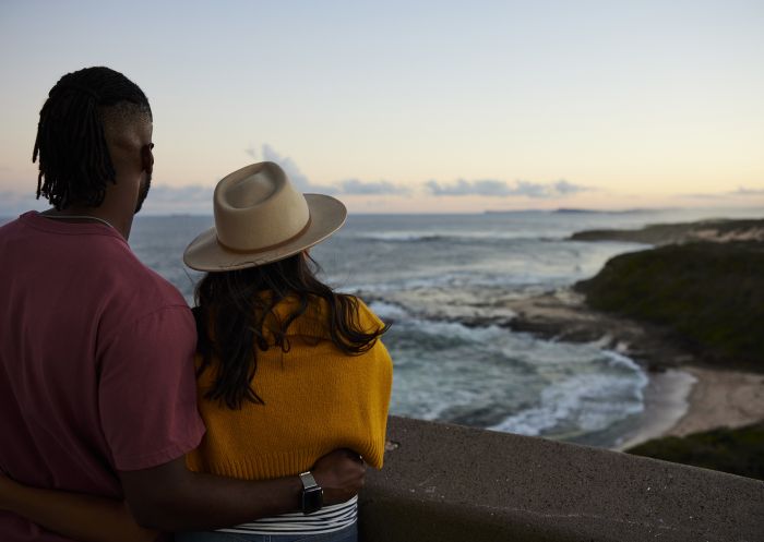 Couple enjoying the scenic coastal views from atop the Norah Head Lighthouse, Norah Head