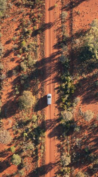 Vehicle approaching Mount Oxley near the town of Bourke in Outback NSW