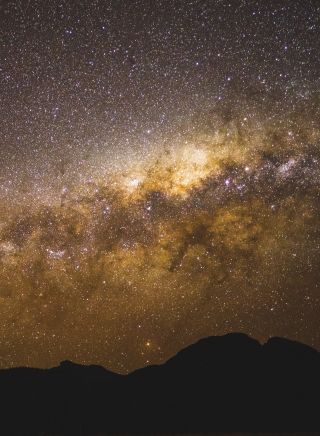 The starry Milky Way above the volcanic silhouette, Warrumbungles